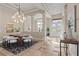 Stunning dining room featuring a modern chandelier, front door view, and decoratively tiled floors at 3138 Lee Shore Loop, Orlando, FL 32820