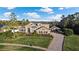 Stunning two-story home featuring lush landscaping, a porte-cochere, and a brick paved driveway at 3138 Lee Shore Loop, Orlando, FL 32820