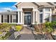 Charming front entrance with a brick pathway, well-manicured landscaping, and double doors at 3138 Lee Shore Loop, Orlando, FL 32820