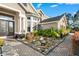 Charming home entrance featuring a stone walkway, beautiful landscaping, and a tranquil water feature at 3138 Lee Shore Loop, Orlando, FL 32820