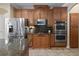 Gourmet kitchen boasts stainless steel appliances, double ovens, and custom wood cabinetry at 3138 Lee Shore Loop, Orlando, FL 32820