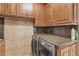 Functional laundry room featuring wooden cabinets, granite countertops, and modern washer and dryer at 3138 Lee Shore Loop, Orlando, FL 32820