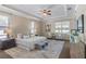 The main bedroom features a tray ceiling, plush carpet, and windows that bring in plenty of natural light at 3138 Lee Shore Loop, Orlando, FL 32820