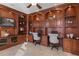 Well-appointed home office featuring custom cabinetry, dual workstations, and a ceiling fan at 3138 Lee Shore Loop, Orlando, FL 32820