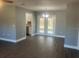 Spacious living room featuring an open floor plan with an adjacent view of the backyard at 33348 Tewksbury Dr, Leesburg, FL 34788