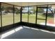 Enclosed patio providing a relaxing space with outdoor views at 33348 Tewksbury Dr, Leesburg, FL 34788