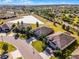 Aerial view of the community homes with a large pond in the distance at 3492 La Jolla Dr, Clermont, FL 34711