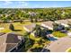 View of community homes featuring manicured lawns and mature trees at 3492 La Jolla Dr, Clermont, FL 34711