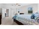 Bright bedroom showcasing a blue patterned bedspread, chair, and view to the side screened patio at 3492 La Jolla Dr, Clermont, FL 34711