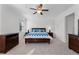 Spacious bedroom featuring dark wood furnishings and carpeting, illuminated by natural light from multiple windows at 3492 La Jolla Dr, Clermont, FL 34711