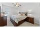 Comfortable bedroom featuring a ceiling fan, window with blinds, and a coordinated furniture set at 3492 La Jolla Dr, Clermont, FL 34711