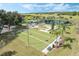 Overhead shot of the bocce ball courts, landscaping, walkways, benches, and mature trees at 3492 La Jolla Dr, Clermont, FL 34711