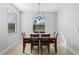 Bright dining room featuring a large window and a modern chandelier above a stylish dining table at 3492 La Jolla Dr, Clermont, FL 34711