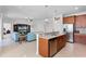 Open concept kitchen showcasing granite countertops, a stainless steel dishwasher, and direct view into the living room at 3492 La Jolla Dr, Clermont, FL 34711