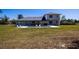 Spacious backyard featuring a rectangular swimming pool, lounge chairs, and a view of the home's rear facade at 36649 Forestdel Dr, Eustis, FL 32736