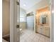 Bathroom featuring cabinet lighting, a window and a shower/tub combination at 36649 Forestdel Dr, Eustis, FL 32736