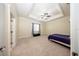 Bedroom featuring plush carpeting, an elegant tray ceiling, and abundant space for relaxation and personalization at 36649 Forestdel Dr, Eustis, FL 32736