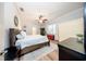 Bedroom featuring hardwood flooring, a ceiling fan, a window, and ensuite bathroom at 36649 Forestdel Dr, Eustis, FL 32736