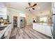 Well-equipped kitchen featuring granite counters, a stainless steel refrigerator, and wood-look floors at 36649 Forestdel Dr, Eustis, FL 32736