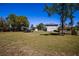 A lush green field with a covered area provides a blend of open space and functional shelter on the property at 36649 Forestdel Dr, Eustis, FL 32736