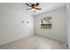 Bright bedroom featuring tile floor, neutral walls, ceiling fan, window with blinds and a built-in shelf at 412 Short Dr, Poinciana, FL 34759