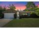 Charming single-story home featuring a stone accent wall and well-maintained lawn at sunset at 412 Short Dr, Poinciana, FL 34759