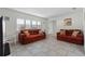 Bright living room features tile floors, plantation shutters, and comfortable seating at 412 Short Dr, Poinciana, FL 34759