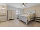 Serene main bedroom with light walls, a ceiling fan, and an ensuite bathroom at 412 Short Dr, Poinciana, FL 34759