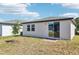 Exterior rear view of home showcasing the backyard and sliding glass door at 4973 Kaia Ave, Winter Haven, FL 33884
