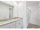 A bathroom featuring a double sink vanity with granite counters, a glass enclosed shower, and a neutral color palette at 4973 Kaia Ave, Winter Haven, FL 33884
