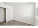 Bedroom with plush carpet, closet, and window providing natural light at 4973 Kaia Ave, Winter Haven, FL 33884