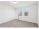 A bright, carpeted bedroom featuring a window and an open door leading to another room at 4973 Kaia Ave, Winter Haven, FL 33884