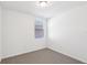 Bedroom with neutral carpet, window, and white walls at 4973 Kaia Ave, Winter Haven, FL 33884