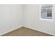 Bedroom with neutral carpet, white walls, and a window with blinds at 4973 Kaia Ave, Winter Haven, FL 33884