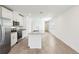 Modern kitchen with white cabinets, stainless steel appliances, granite countertops, and a kitchen island at 4973 Kaia Ave, Winter Haven, FL 33884