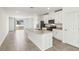 Modern kitchen with white cabinets, stainless steel appliances, granite countertops, and a kitchen island at 4973 Kaia Ave, Winter Haven, FL 33884