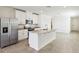 Modern kitchen with white cabinets, stainless steel appliances, granite countertops, and a kitchen island at 4973 Kaia Ave, Winter Haven, FL 33884