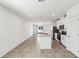 Open-concept living space with a view of the kitchen featuring stainless steel appliances and granite countertops at 4973 Kaia Ave, Winter Haven, FL 33884