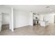 Open-concept living space with a view of the kitchen featuring stainless steel appliances and granite countertops at 4973 Kaia Ave, Winter Haven, FL 33884