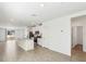 Open-concept living space with a view of the kitchen featuring stainless steel appliances and granite countertops at 4973 Kaia Ave, Winter Haven, FL 33884