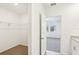 A walk-in closet with wire shelving on a neutral wall, adjacent to a carpeted bedroom at 4973 Kaia Ave, Winter Haven, FL 33884