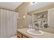 Bathroom featuring a vanity, mirror, shower with neutral decor, and a laundry area at 5481 Limestone Ln # 5481, Lakeland, FL 33809