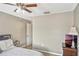 Neutral bedroom with a ceiling fan, lamp, and doorway leading to other parts of the home at 5481 Limestone Ln # 5481, Lakeland, FL 33809