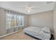 Well-lit bedroom with large windows and neutral decor for a relaxing atmosphere at 5481 Limestone Ln # 5481, Lakeland, FL 33809