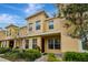 Inviting exterior of a two-story townhome featuring manicured landscaping and a warm, neutral color palette at 5481 Limestone Ln # 5481, Lakeland, FL 33809