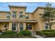 Charming townhome showcasing a well-maintained facade, lush bushes, and a neatly manicured landscape at 5481 Limestone Ln # 5481, Lakeland, FL 33809