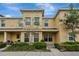 Charming townhome featuring a well-kept exterior, lush bushes, and a nicely manicured landscape at 5481 Limestone Ln # 5481, Lakeland, FL 33809