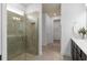 Modern bathroom with a glass-enclosed shower, neutral tile, and a sleek vanity at 6017 Wildline Dr, St Cloud, FL 34771