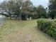 Expansive backyard features mature trees, chain link fence, and white picket fence at 63 Dahlia Dr, Debary, FL 32713