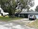 Exterior view of a home featuring a spacious driveway and mature landscaping at 63 Dahlia Dr, Debary, FL 32713